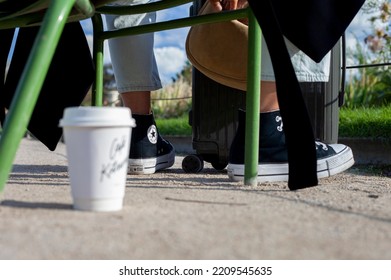 
PARIS, FRANCE - October 03, 2022: Black And White Converse Sneakers And A Glass Of Coffee