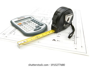 Paris, France - October 09, 2010: Tape measure with a calculator on the drawing plan of architectural  and construction project, isolated on white background