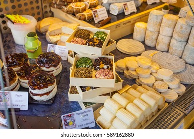 PARIS, FRANCE -OCTOBER 1 : French Cheese Shop With Dozens Of Kinds Of Chees And Customers Choosing Among Them On October 1, 2016 In Paris, France