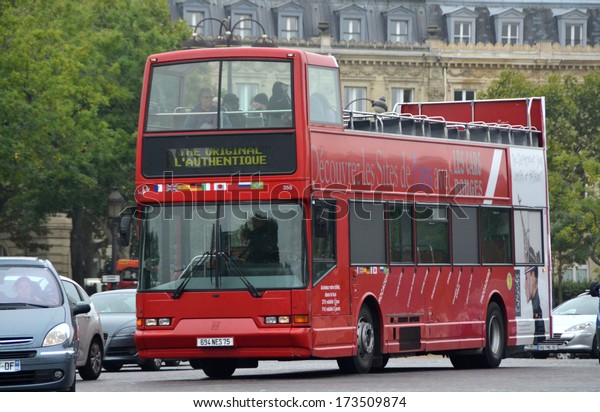 PARIS, FRANCE - OCTOBER 18:\
Tourist Bus in Paris, France on October 18, 2013. Les Cars Rouges\
is a touristic bus service that shows the city with an audio\
guide.