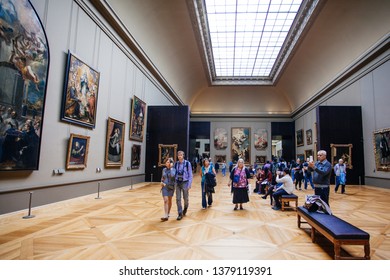 Paris, France - October 2, 2016: Tourists visit art gallery in the Louvre Museum. The Louvre Museum is one of the largest and most visited museums worldwide