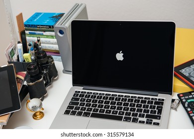 PARIS, FRANCE - SEP 10, 2015: Apple Computers Website On MacBook Pro Retina In A Creative Room Environment Showcasing  Apple Logo On Retina Display