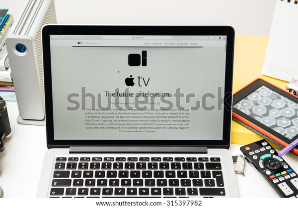 PARIS,\
FRANCE - SEP 10, 2015: Apple Computers website on MacBook Pro\
Retina in a creative room environment showcasing the newly\
announced Apple TV - the future of\
television
