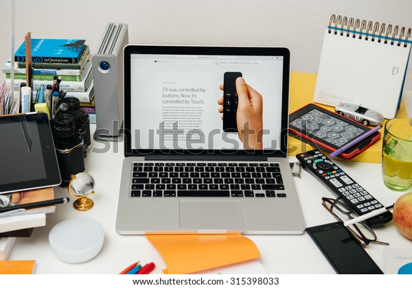PARIS,\
FRANCE - SEP 10, 2015: Apple Computers website on MacBook Pro\
Retina in a creative room environment showcasing the newly\
announced new Apple TV with remote control,\
swipe,