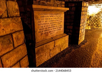 Paris, France, France - Sep 11, 2019:  A monument stands dimly lit in the depths of the catacombs of Paris, France.