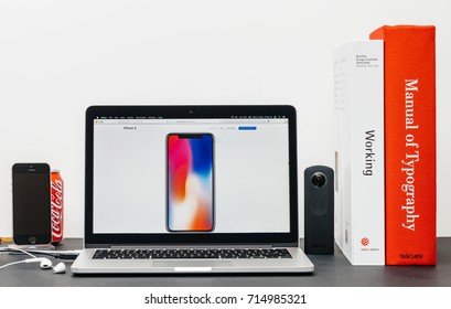 PARIS, FRANCE - SEP 13, 2017: Minimalist Creative Room Table With Safari Browser Open On MacBook Pro Laptop Showcasing Apple Website With Latest IPhone X 10 With Iphone Body With Colorful Wallpaper 