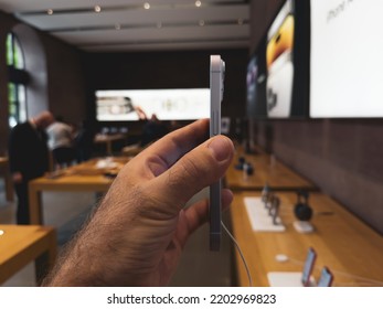 Paris, France - Sep 16, 2022: Side View Of Male Hand Holding New Purple Colored Apple Computers IPhone 14 During The Launch Day Featuring New Dual Powerful Camera Car Crash Detection; And Satellite