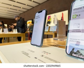 Paris, France - Sep 16, 2022: Hero Object Of New Purple Colored Apple Computers IPhone 14 During The Launch Day Featuring New Dual Powerful Camera Car Crash Detection; And Satellite SOS - People In