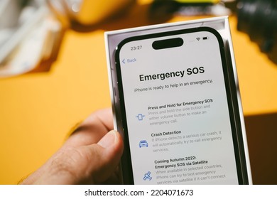 Paris, France - Sep 17, 2022: Male Hand Holding Packge With New Apple Computers IPhone 14 Pro Smartphone Telephone With Emergency SOS Menu - Crash Detection And Sos Emergency Via Satellite - Operation