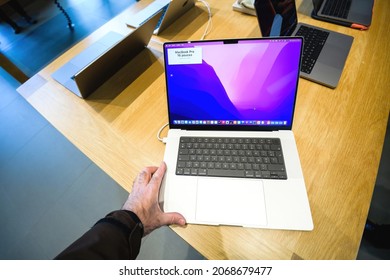 Paris, France - Sep 24, 2021: Male hand looking at the new Apple Computers MacBook book pro 16 inch laptop featuring an all-new design with more ports, no Touch Bar, MagSafe, M1 Pro and M1 Max chips