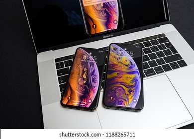 PARIS, FRANCE - SEP 25, 2018: New IPhone Xs And Xs Max Smartphones Model By Apple Computers Close Up Photo On The Keyboard Of Apple MacBook Pro Laptop 15 Inch - Wallpaper Liquid