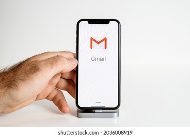 Paris, France - Sep 25, 2018: POV Male Hand Touching The New Apple Computers IPhone 13 Smartphone With Running Gmail Email App Application And Sign In Button - Isolated On White