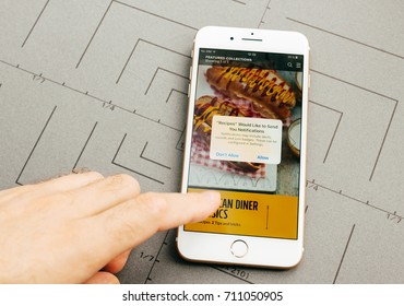 PARIS, FRANCE - SEP 26, 2016: Male Hand Holding New Apple IPhone 7 Plus After Unboxing And Testing By Installing The App Application Software Food App By Jamie Oliver