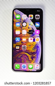 PARIS, FRANCE - SEP 27, 2018: new iPhone Xs Max smartphone model by Apple Computers close up with all home apps against - isolated on white
