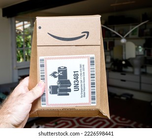 Paris, France - Sep 8, 2021: Living Room Background Package Of Amazon Prime Cardboard Package With UN3481 Stiker Norme Lithium Batteries Are Dangerous Goods And, As Such, Require Special Packaging