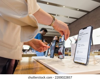 Paris, France - Sep 9, 2022: Woman Looking At The New IPhone 13 And 14 Pro Max With Customers And Genius Workers In Apple Store