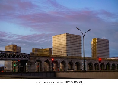 Paris, France - Sept. 2020 - Night View Of Pont De Bercy, An Arched Railway Bridge Supporting A Metro Line , With The Cityscape Of BNF-François Mitterrand Business District In The Background