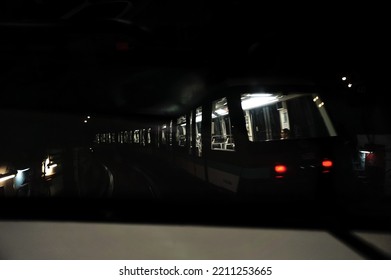 Paris, France - Sept. 2022 - Motion-blurred Shot Of A Metro Train, Rolling Inside An Underground Tunnel ; The Interior Of The Train Is Lit, While The Outside Is Dark, Which Creates A Clair-obscur