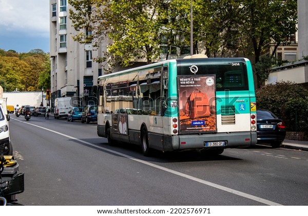 Paris, France - September 05, 2022 Bus driving\
through the streets of Paris, Buses are inexpensive and drop you\
off at any location in the capital quite quickly, many of its buses\
run on gas\
