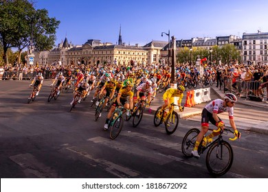 Paris, France - September 20, 2020: Yellow Jersey riding in front of the peloton on Pont Neuf bridge in Paris during the last stage of Le Tour de France 2020.