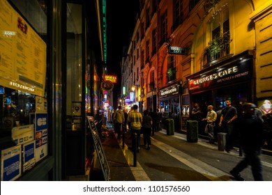 Paris, France - September 23 2017: Bouncers Watch Tourists And Locals Pass By Outside A Bar Late At Night In The Latin Quarter Of Paris France