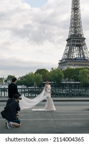 Paris, France - September 23 2019: A wedding photo shoot at Pont de Bir Hakeim Bridge with Eiffel Tower in the background