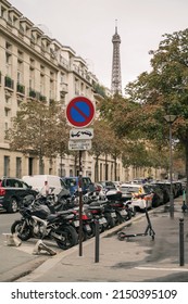  Paris, France -  September 23 2019: Motorcycles and vehicles street parking at Frédéric le Play Avenue with the Eiffel Tower in the background.                            