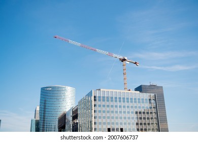 Paris, France - September 29, 2017: construction crane over skyscrapers. Building construction in La Defense. Modern architecture and construction. Prospect and progress. Growth and development