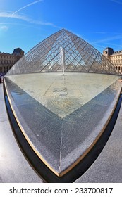 PARIS, FRANCE - SEPTEMBER 8, 2012: The World-famous Entrance To  Louvre - The Glass Pyramid And Spectacular Fountain. Picture Taken Fisheye Lens