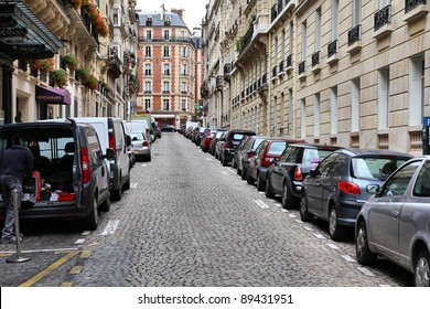 Paris, France - Typical Old City Street. Cars Parked Along Cobblestone Way.