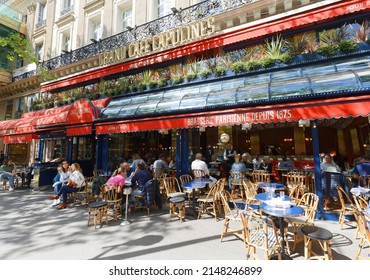 Paris, France-April 15 , 2022 : Le Grand Cafe Capucines is the legendary and famous brasserie on Grands Boulevards. Inscription in French on sign: Parisian brasserie since 1875.
