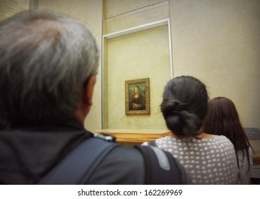 Paris, France-July 24, 2013: Group Of Tourists Gathered Around The Mona Lisa In The Louvre Museum