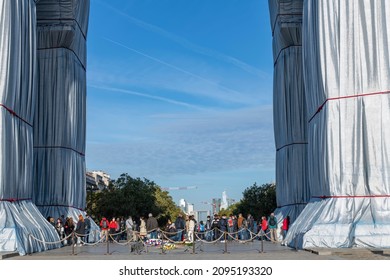 Paris, France-September 2021; View through the pillars of wrapped Arc de Triomphe art installation by Christo on Place Charles de Gaulle with red ropes and polypropylene fabric filled