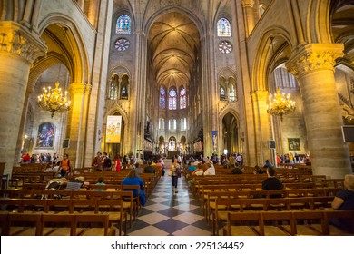 PARIS - JUNE 21: Unidentified tourists visiting the Notre Dame de Paris on June 21, 2014 in Paris. The cathedral of Notre Dame is one of the top tourist destinations in Paris.