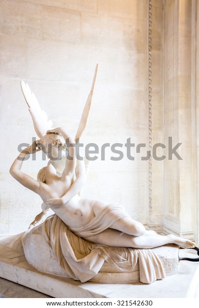 Paris - June 23: Cupid statue on June 23, 2014\
in Paris. Antonio Canova\'s statue Psyche Revived by Cupid\'s Kiss,\
first commissioned in 1787, exemplifies the Neoclassical devotion\
to love and emotion.