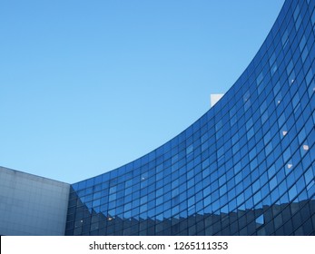 Paris La Defense, france - December 1 2018 : curved shape office buildings with glass facade. Business district. evening light. blue sky.