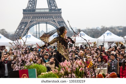 PARIS - MARCH 24: Dancer In Traditional Persian Costume And Eiffel Tower At Background As Seen On March 24, 2013 In Paris, France. Iranian Community In Paris Celebrates The Nowruz (Iranian New Year).