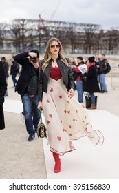PARIS - MARCH 8, 2016: Stylish European woman in the Tuileries Garden. Paris Fashion Week: Ready to Wear 2016/2017 is held from March 1 to 9, 2016.