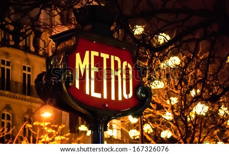 Paris Metro subway sign and Christmas illumination. 