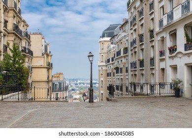 Paris, Montmartre, Typical Street With A Vintage Lamppost, Beautiful Buildings And Staircase