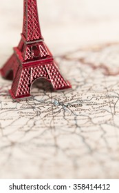 Paris name at a map with red Eiffel tower miniature (blurred copy space)/Travel Destination Paris
