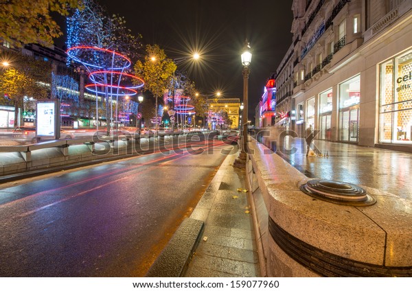 PARIS, NOV 30: Car light trails in\
famous Champs Elysees, November 30, 2012 in Paris. The avenue runs\
for 1.91 km (1.18 mi) through the 8th\
arrondissement.