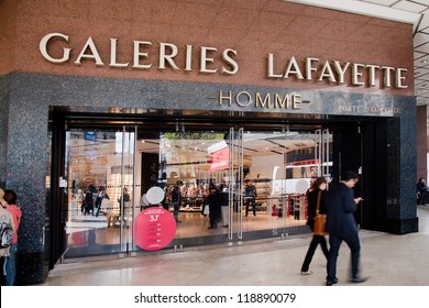 PARIS - OCT 2: Shoppers Walk Past The Entrance To Lafayette Shopping Center On October 2, 2012 In Paris. The Galeries Lafayette Has Been Selling Luxury Goods Since 1895.