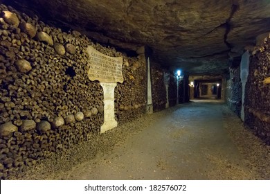 PARIS - OCT 25, 2013: Catacombs of Paris, France. Famous Catacombs (Les catacombes de Paris) are underground ossuaries and tourist attraction. Museum in the old vault. Scary tunnel with human bones.