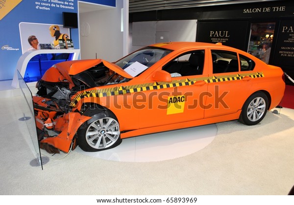 PARIS - OCTOBER\
12: Crash test with a BMW displayed at the 2010 Paris Motor Show on\
October 12, 2010 in\
Paris.