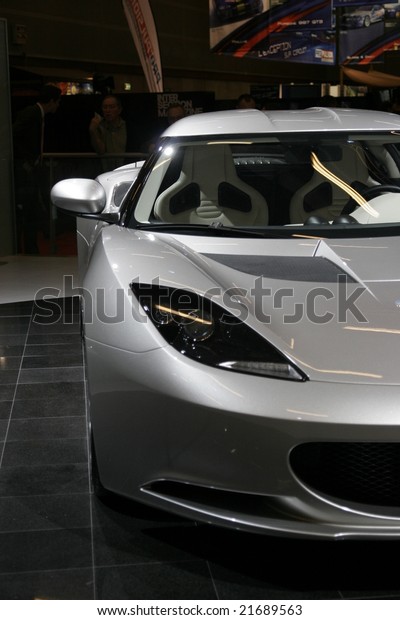 PARIS - OCTOBER 13 : People\
look at the Lotus evora at the 2008 Paris Motor Show October 13,\
2008 in Paris. The show attracts more of one million people every 2\
years