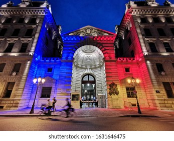 Paris police station headquarters lit up with French flag colors as cyclists ride by  - Shutterstock ID 1631646475