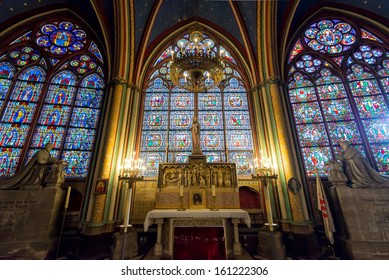 PARIS - SEPT 25, 2013: Interior of the Notre Dame de Paris cathedral with stained-glass windows, France. Notre Dame is one of the top tourist attractions in Paris. Inside the Gothic landmark of Paris.