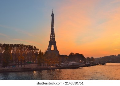 Paris skyline with Eiffel Tower at sunset.