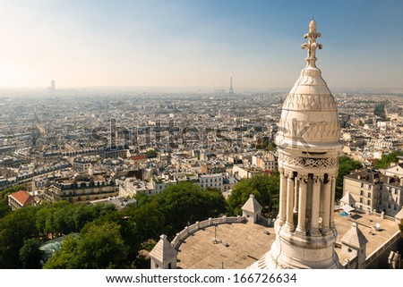 Paris view from Sacre Coeur on Montmartre hill, France. Basilica of Sacre Coeur (Sacred Heart) is famous landmark of city. Nice panorama, skyline of Paris in summer. Sightseeing of Montmartre.
